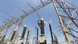 A technician repairs power supply lines at a power plant of Adani Power at Mundra Port in the western Indian state of Gujarat on 2 April 2014. Photo: Amit Dave/Reuters/File Photo