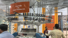 Visitors examine a circular knitting machine displayed at the 19th Dhaka International Textile and Garment Machinery Exhibition on 21 Friday. The expo, featuring over 1,100 global brands, showcases cutting-edge textile technology and equipment at the International Convention City Bashundhara (ICCB) in Dhaka. Photo: TBS