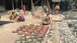 Earthen pots dried in the sun, dipped in colours, and burned. Potters in Bagerhat struggle to sustain amid decreasing demands. Photo: TBS