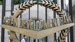 A worker walks past inside the Asian Development Bank (ADB) headquarters in Manila, 17 June 2009. Photo: Reuters