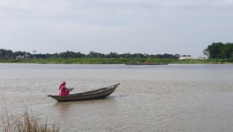 File photo of woman rowing boat on Padma River. Photo: UNB