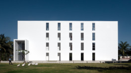 The NAAF Dormitory in Teknaf presents a minimalist white façade, its clean geometry and elongated form responding to the surrounding river landscape. Photos: Courtesy 