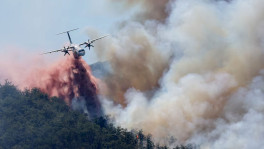 A firefighting plane drops water, following a wildfire in Ille-sur-Tet near Perpignan, France, July 6, 2026. Photo: REUTERS/Alexandre Dimou